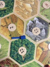 This is why i don't play Catan. I make foolish mistakes like this one and actually place a settlement here. Part way into the game I fully realized that everyone else was picking up cards everytime the dice rolled....and not me! At LEAST I got blue houses....love blue!